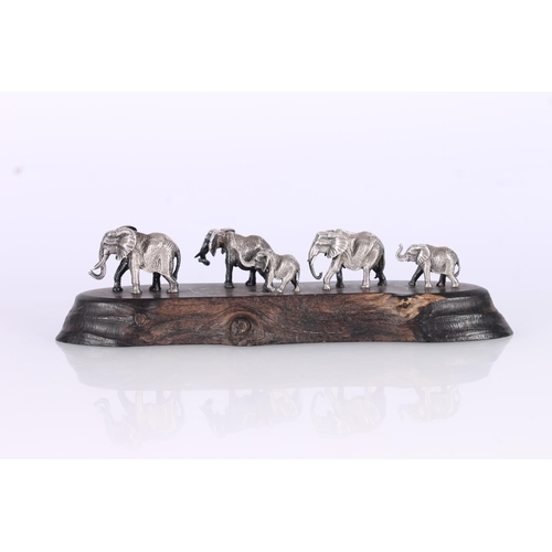 80 - Patrick Mavros (Zimb. 20th century); Small silver elephant family on ebony hardwood base, PM monogra... 