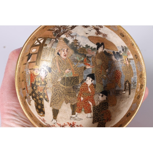 338 - Japanese Satsuma pottery bowl, late Meiji period, decorated with a village showman and children by a... 