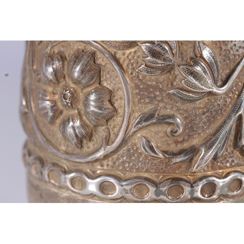 81 - Arts and Crafts silver cup, the round body hand decorated in relief with scrolling foliate designs o... 