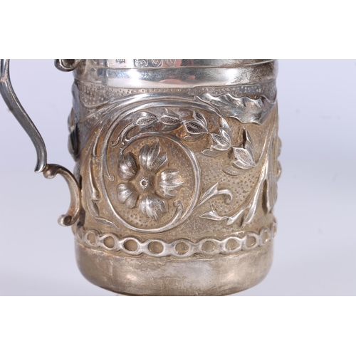 81 - Arts and Crafts silver cup, the round body hand decorated in relief with scrolling foliate designs o... 