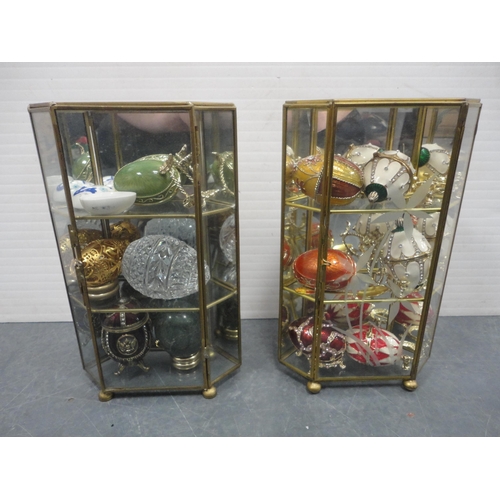104 - Quantity of assorted mineral egg ornaments, two display cases containing Fabergé-style egg or... 