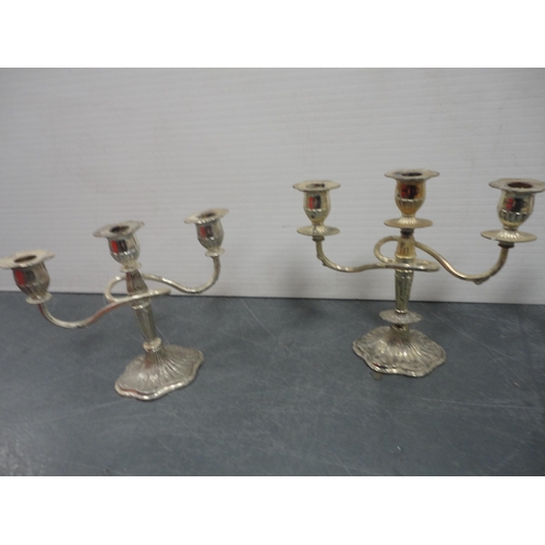 114 - Three reproduction candelabra and a pair of candlesticks.