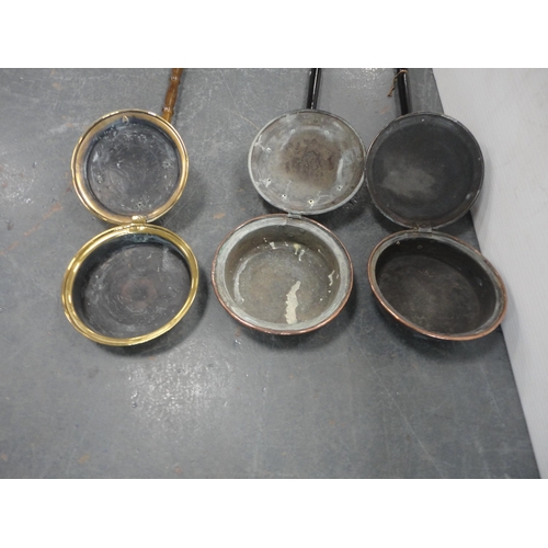 184 - Two brass-mounted bed warming pans and a copper bed warming pan.  (3)