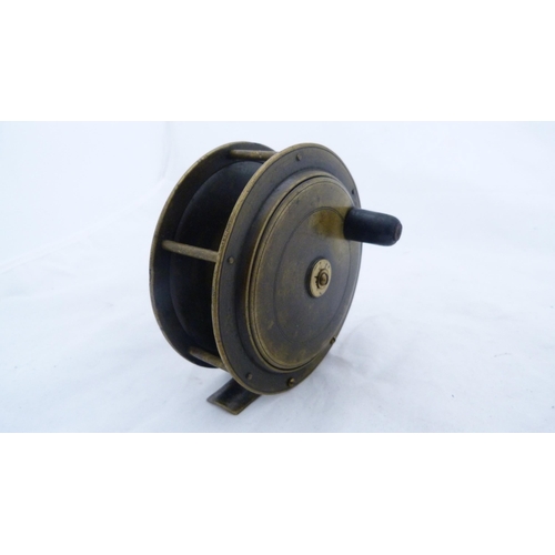 239 - Antique brass fishing reel, named indistinctly, another of similar size and a wooden and brass-mount... 