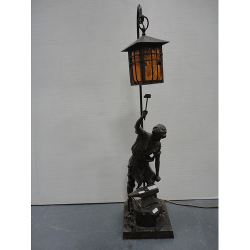 25 - Metal table lamp in the form of a blacksmith at the anvil.