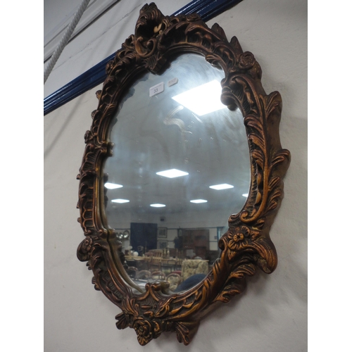 33 - French-style scroll decorated wall mirror.