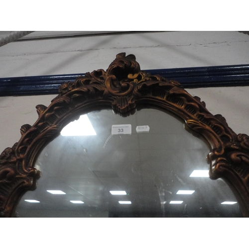 33 - French-style scroll decorated wall mirror.