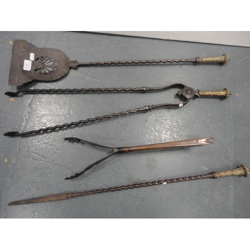 35 - Near-set of three antique Georgian-style iron and brass fire irons and a later pair of tongs.