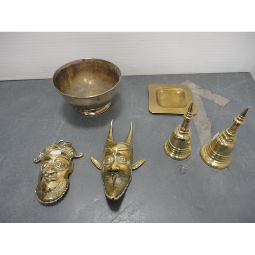 40 - Brassware to include wall masks, bells, Oriental-style vessel and cover, bowl, dish, oil lamp conver... 