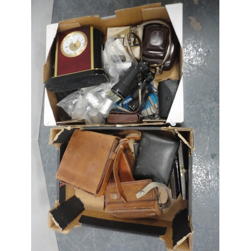 86 - Two cartons containing cameras, modern mantel clock, binoculars, accessories, light meters, instrume... 