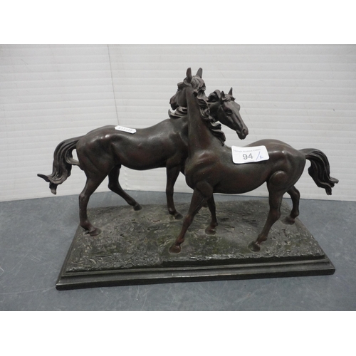 94 - Bronzed figure group of two horses on a naturalistic base and a similar figural mantel clock.  (2)