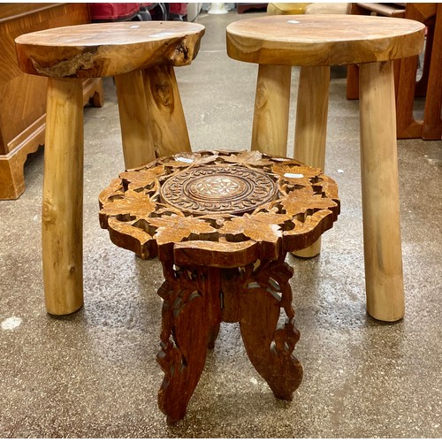 670 - Two rustic look milking stools and an ornately carved stool with mother of pearl inlay