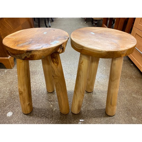 670 - Two rustic look milking stools and an ornately carved stool with mother of pearl inlay