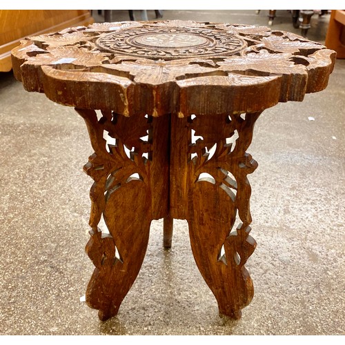 670 - Two rustic look milking stools and an ornately carved stool with mother of pearl inlay