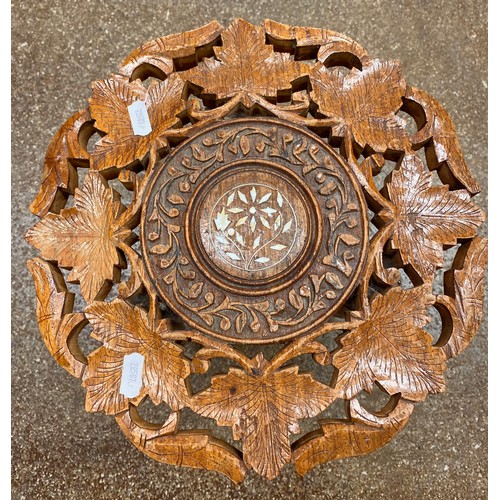 670 - Two rustic look milking stools and an ornately carved stool with mother of pearl inlay