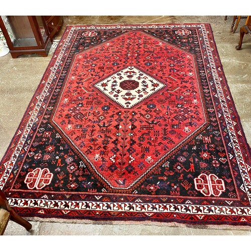 656 - Large red ground woollen rug