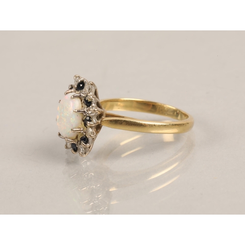 209 - Gold ring, marks illegible, set with an opal surrounded by diamonds and blue stones, ring size J, 3.... 