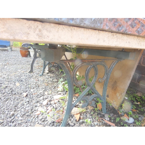 532 - Marble top garden table, cast iron frame 122cm x 60cm.