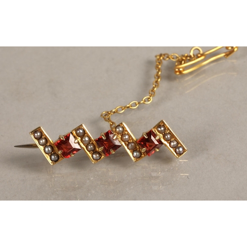 148 - 14K gold brooch set with seed pearls and orange red gems, a 9ct brooch set with a pink gem and anoth... 