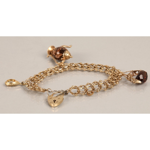 176 - 9ct gold charm bracelet with heart padlock and three gold charms (one gem set spinner fob, one with ... 