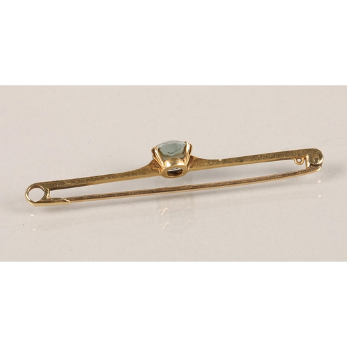 37 - 15ct gold bar brooch set with a pale blue stone, 3.4g