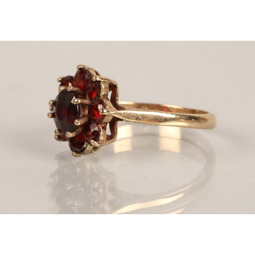 76 - 9ct gold ring set with cluster of ruby coloured gems, ring size M/N, 3g, 