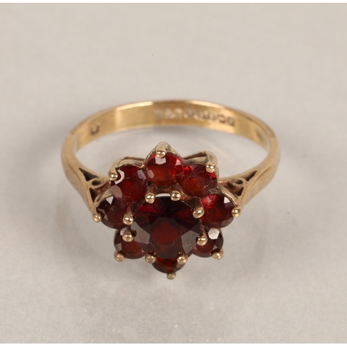 76 - 9ct gold ring set with cluster of ruby coloured gems, ring size M/N, 3g, 