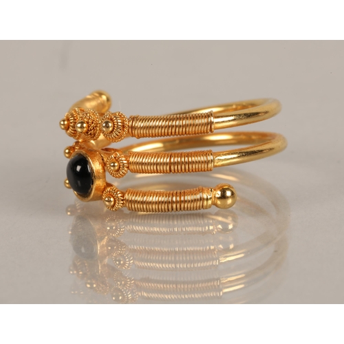 92 - High karat yellow gold ring set with a black gem, illegibly marked, 5.9g, ring size M/N