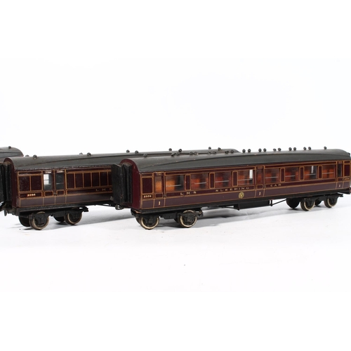 1117 - Four wood built O gauge model railway LMS carriages to include first class coach, third class coach,... 