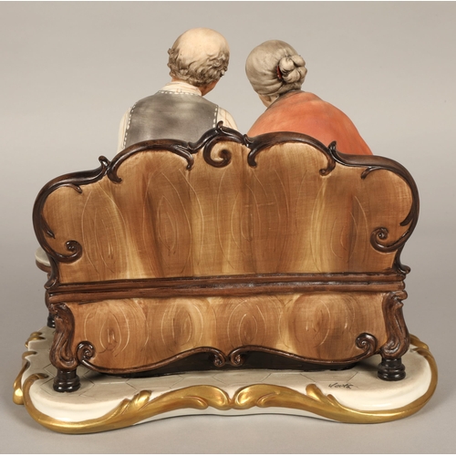 17 - Capodimonte figure, elderly couple seated