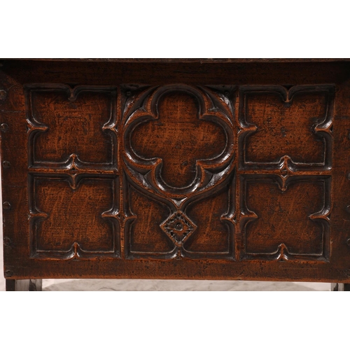 382 - Small oak coffer chest, the front panel deep carved in the gothic fashion, plain plank sides and hin... 