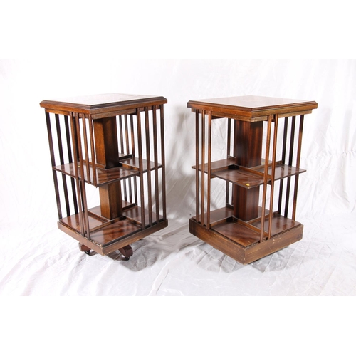 385 - Two Edwardian revolving bookcases with inlaid marquetry tops and slatted compartments, max H85cm.