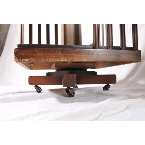 385 - Two Edwardian revolving bookcases with inlaid marquetry tops and slatted compartments, max H85cm.