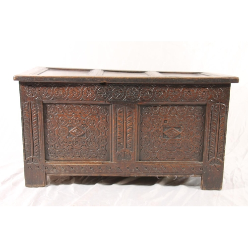 386 - 18thC oak coffer, with three panel hinged top over chip carved front and stile legs, W96cm.