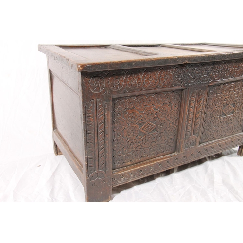 386 - 18thC oak coffer, with three panel hinged top over chip carved front and stile legs, W96cm.