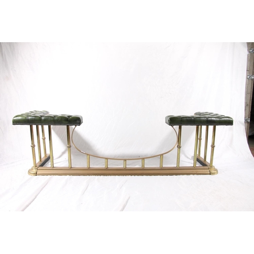 387 - 20thC brass and leather club fender, the green deep button seats on brass shaped frame, max W186cm.