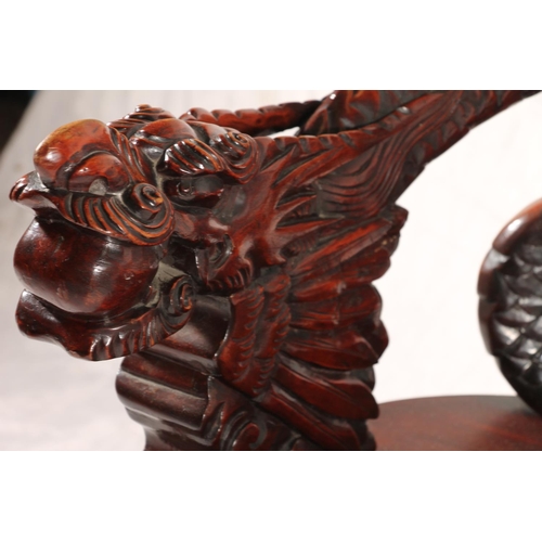 391 - Chinese export hardwood elbow chair, the eagle surmount crest leading to carved dragon splat, shaped... 