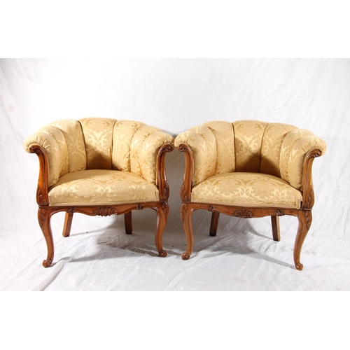 393 - Pair of Italian Art Deco walnut framed parlour tub chairs, shell form cushioned back over padded sea... 