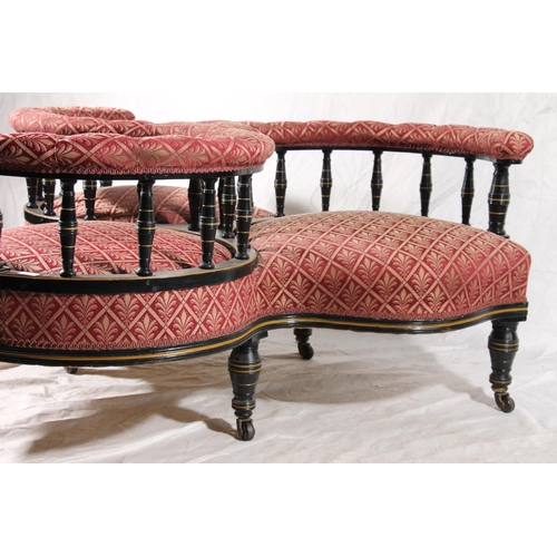 399 - Victorian triple conversation seat, the three upholstered padded armrests on turned black and gilt p... 