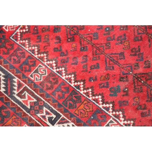 420 - Persian nomad tribal rug, the three central medallions on a red ground, 307cm x 215cm.