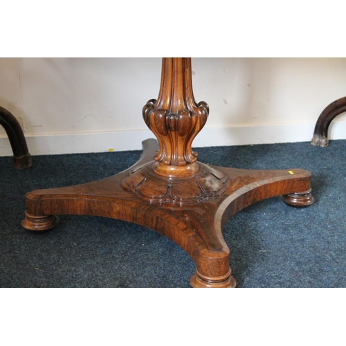 344 - William IV rosewood tilt top dining table, the oval top supported on baluster and petal column, term... 