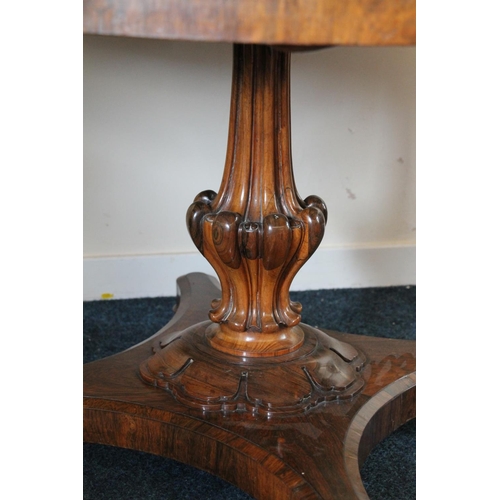 344 - William IV rosewood tilt top dining table, the oval top supported on baluster and petal column, term... 