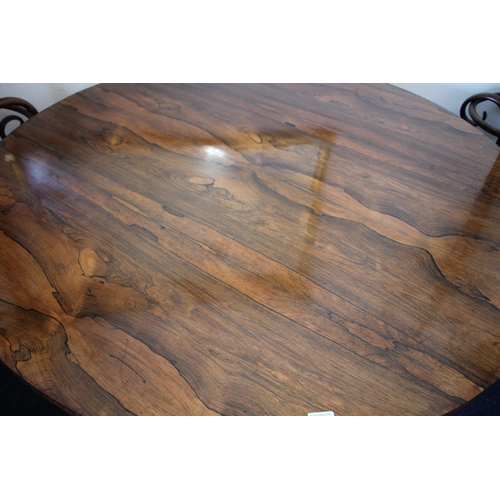 344 - William IV rosewood tilt top dining table, the oval top supported on baluster and petal column, term... 