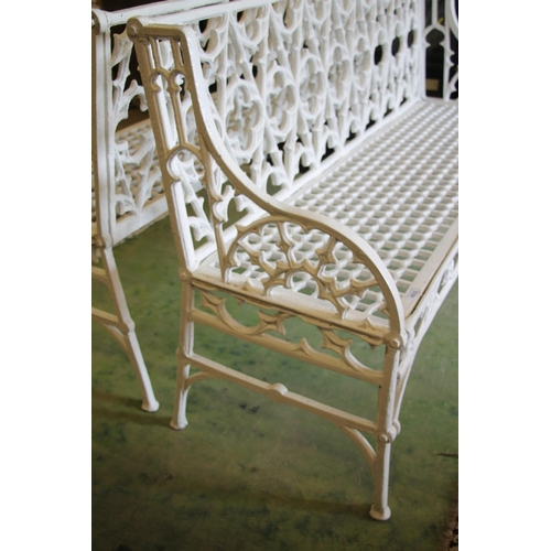 375 - Pair of white painted metal garden benches, with gothic fretwork back over honeycomb seat, armrests ... 