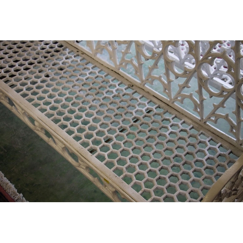 375 - Pair of white painted metal garden benches, with gothic fretwork back over honeycomb seat, armrests ... 