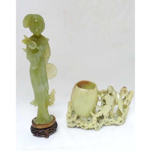 352 - Chinese carved lime jade figure of a Geisha, probably Republic period, holding a lotus flower in her... 