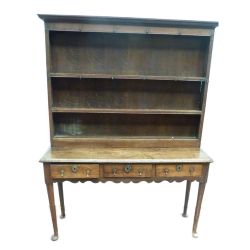 509 - 18th century oak dresser with open Delft shelving above three short drawers to the base, on pad feet... 