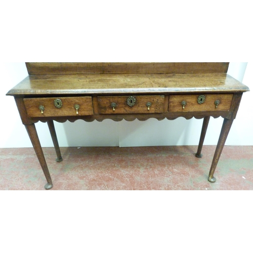 509 - 18th century oak dresser with open Delft shelving above three short drawers to the base, on pad feet... 