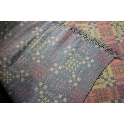 294 - Welsh wool blanket, double sided and fringed with geometric decoration on a polychrome grid backgrou... 