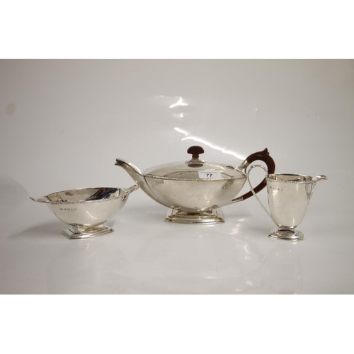 77 - Art Deco three piece silver tea set, of typical geometric symmetrical shape, the teapot with moulded... 